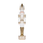 Gold and white nutcracker with feather and jewel on hat