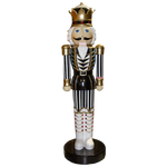Oversized nutcracker king with black and white striped sleeves and pants, white boots and hair and golden crown