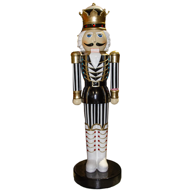 Oversized nutcracker king with black and white striped sleeves and pants, white boots and hair and golden crown
