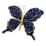 Clip-on decorative butterfly with blue sequin wings and champagne glitter detailing