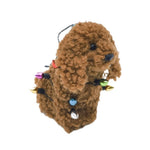 Brown fluffy cavoodle dog wrapped in Christmas lights hanging ornament